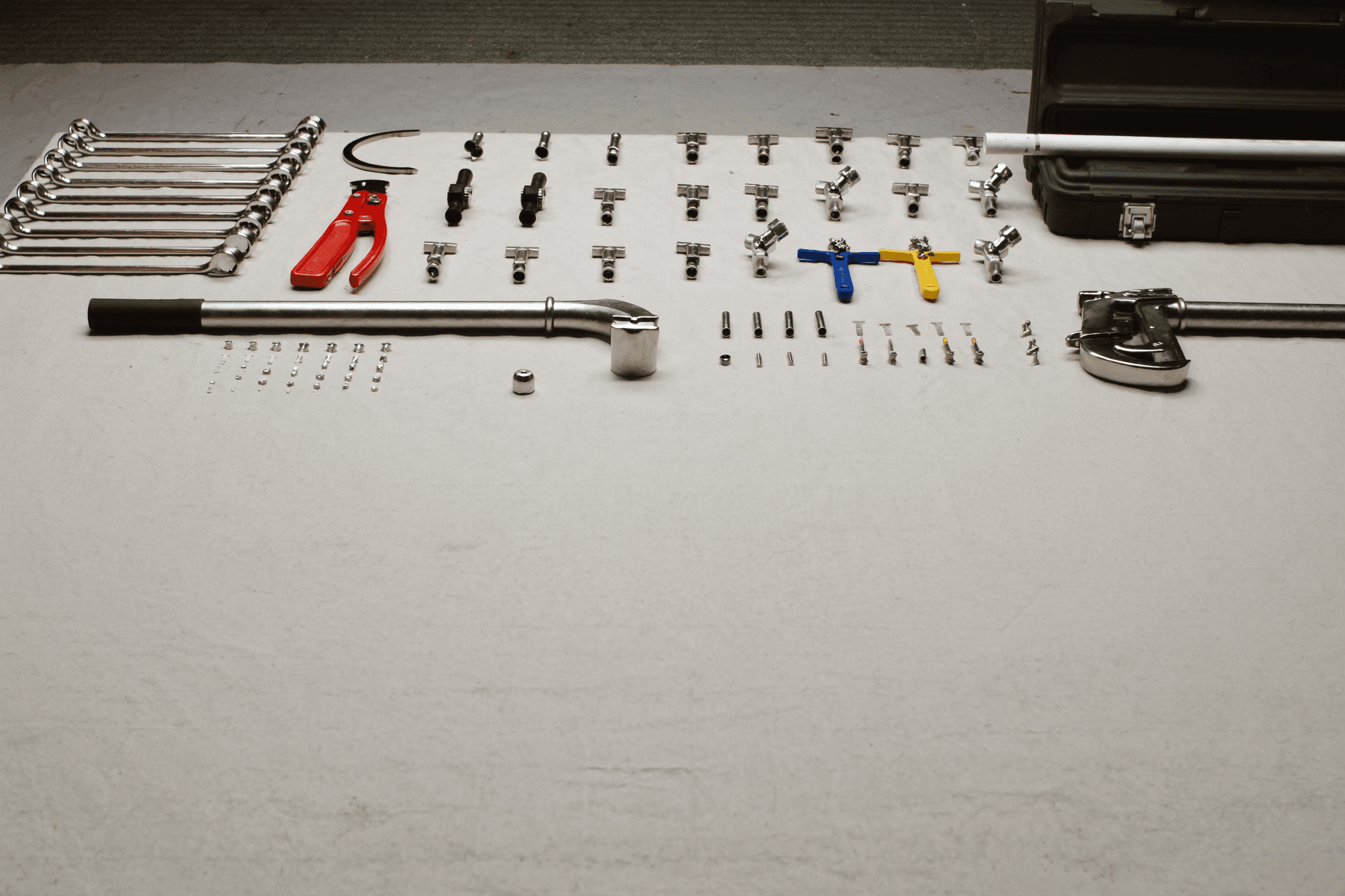 Professional plumbing tools laid out flat and organized